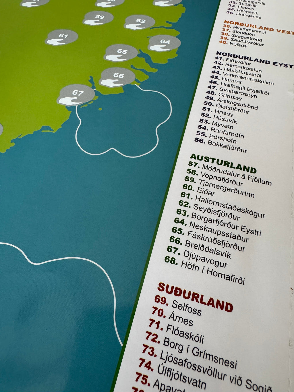 Nærmynd af Skraf skafkorti fyrir frisbígolfvelli Íslands sem sýnir skafreiti á Austurlandi og yfirlitslista yfir alla frisbígolfvelli landsins flokkaða eftir landshlutum með númerum og nöfnum.
